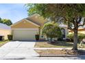 Inviting single-Gathering home features a two-car garage and well-maintained landscaping at 4579 Westgrove Way, Orlando, FL 32808