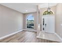 Bright foyer with a decorative window, a front door and durable tile flooring at 4579 Westgrove Way, Orlando, FL 32808
