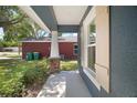 Covered entryway featuring a traditional front door, column, and window with shutters at 510 Fahnstock St, Eustis, FL 32726
