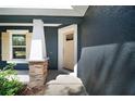Close up of home's entrance with front door and white porch columns with stone detailing at 510 Fahnstock St, Eustis, FL 32726