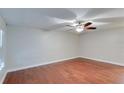 Bright bedroom with wood floors, ceiling fan, white walls, and ample natural light at 5518 Cretan Way, Winter Park, FL 32792