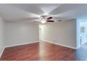 Spacious living room featuring beautiful wood-look floors and a ceiling fan at 5518 Cretan Way, Winter Park, FL 32792