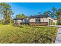 Side view of home with craftsman architectural details and driveway at 5531 Dallas Blvd, Orlando, FL 32833