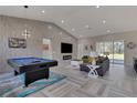 Open floor plan with modern decor, a vaulted ceiling, and a textured accent wall at 5531 Dallas Blvd, Orlando, FL 32833