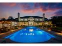 Backyard view of the property featuring a beautiful pool, patio and a manicured lawn that backs up to the home at 570 Manor Rd, Maitland, FL 32751