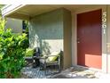 Inviting front porch with seating area to enjoy the outdoors at 5961 Windhover Dr # F05, Orlando, FL 32819