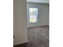 Cozy bedroom featuring neutral carpet, a window with blinds, and freshly painted walls at 604 Sarner Pass Way, Winter Haven, FL 33881