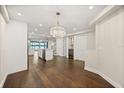 Elegant dining area with a crystal chandelier flows into the stylish kitchen and living spaces at 640 Killarney Bay Ct # 4, Winter Park, FL 32789