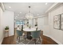 Elegant dining area featuring a round table, chandelier, and natural light with lake views through the doorway at 640 Killarney Bay Ct # 4, Winter Park, FL 32789