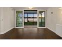 Inviting living room boasts gleaming hardwood floors and sliding glass doors with serene lake views at 640 Killarney Bay Ct # 4, Winter Park, FL 32789