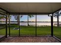 Relaxing screened patio with brick pavers offers a peaceful view of the tranquil lake at 640 Killarney Bay Ct # 4, Winter Park, FL 32789