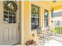 Charming front porch featuring comfortable seating, a decorative wreath, and classic architectural details at 7545 Azalea Cove Cir, Orlando, FL 32807