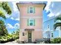 Peach home with a patio, table, and hot tub at 8001 Sand Bar Dr, Kissimmee, FL 34747