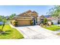Beautiful two-story tan home with a well-manicured lawn and brick-paved walkway at 8856 Hastings Beach Blvd, Orlando, FL 32829