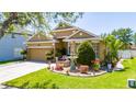 Attractive home with a well-maintained lawn and charming front garden featuring a water fountain at 8856 Hastings Beach Blvd, Orlando, FL 32829