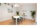 Bright dining room featuring modern table and chairs, plants, and natural light at 935 Amy Ridge Ct, Kissimmee, FL 34747