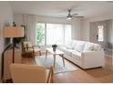 Cozy living room with abundant natural light, ceiling fan, and modern furnishings at 935 Amy Ridge Ct, Kissimmee, FL 34747