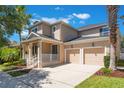 Inviting two-story home featuring a front porch and a two-car garage at 9963 Hartford Maroon Rd, Orlando, FL 32827