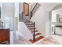 Bright foyer showcasing tile floors, staircase with decorative iron railing, and an open design at 9963 Hartford Maroon Rd, Orlando, FL 32827