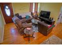Inviting living room featuring hardwood floors, cozy furniture, and natural light, ideal for relaxation and gatherings at 1 Cosmos Dr, Orlando, FL 32807