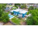 This house has blue siding, a white roof, a swimming pool, a deck, and a large manicured backyard at 1046 Blackwood St, Altamonte Springs, FL 32701