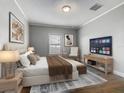 Serene bedroom featuring a cozy bed, soft lighting, and a television for relaxing evenings at 107 Carlisle Ct, Kissimmee, FL 34758