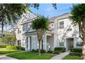 Attractive townhouse featuring a well-maintained lawn and picturesque landscaping at 112 Southern Pecan Cir # 201, Winter Garden, FL 34787