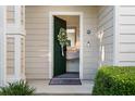 Inviting front door leads to an entry featuring charming vanity at 112 Southern Pecan Cir # 201, Winter Garden, FL 34787