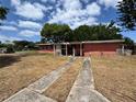 Single story home with small covered porch and long driveway needing repairs in an established neighborhood at 122 Laurel Dr, Sanford, FL 32773