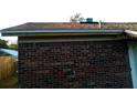 Exterior view highlighting brick detail, brown roof, and backyard with wood fence at 135 Bob Thomas Cir, Sanford, FL 32771