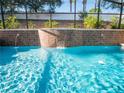 Backyard pool featuring a tiled water wall with multiple fountains, adding a luxurious touch at 1870 Vale Dr, Clermont, FL 34711