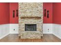 Close up view of a stone fireplace featuring a wood mantel and hearth at 194 Heron Bay Cir, Lake Mary, FL 32746