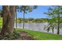 The lush backyard has mature trees and direct access to the serene lake at 200 Maitland Ave # 153, Altamonte Springs, FL 32701