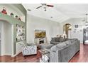 Bright and airy living area with comfortable seating, built-in shelving, and wood floors at 2848 Wilshire Rd, Clermont, FL 34714