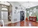 Elegant entryway featuring high ceilings, wood floors, and stylish decor at 2848 Wilshire Rd, Clermont, FL 34714