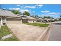 Street view of well-maintained townhomes with manicured lawns, garages, and neighborhood charm at 35 Misners Trl, Ormond Beach, FL 32174