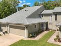 A view from above of a townhome with a new roof, manicured landscaping and a one car garage at 35 Misners Trl, Ormond Beach, FL 32174