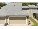 Charming townhome featuring a neutral exterior, updated roof, and two-car garage at 35 Misners Trl, Ormond Beach, FL 32174