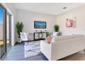 Bright living room featuring a cozy sofa, stylish decor, and large sliding glass doors at 3761 Shoveler Ave, Leesburg, FL 34748