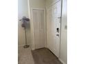 Inviting entryway with closet, a front door with modern lock, hat stand, and neutral decor at 4244 Sun Village Ct # 160, New Smyrna Beach, FL 32169