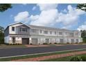 Charming townhomes feature attached garages, neutral colors, brick accents, and inviting entryways at 4291 Campsite Loop, Orlando, FL 32824