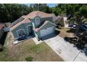 Aerial view of a charming two-story home featuring a well-maintained lawn and solar panels at 4381 Creekside Blvd, Kissimmee, FL 34746