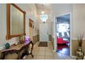 Inviting foyer with decorative mirror and decor, leading into a bright, spacious living area at 4381 Creekside Blvd, Kissimmee, FL 34746