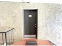 Condo entrance showing door number 203 on a textured wall at 455 Wymore Rd # 203, Altamonte Springs, FL 32714