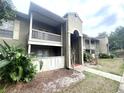 Condo complex featuring private balconies, neutral paint, and lush landscaping at 455 Wymore Rd # 203, Altamonte Springs, FL 32714