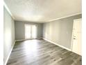 Bright living room with neutral walls and modern vinyl plank flooring at 455 Wymore Rd # 203, Altamonte Springs, FL 32714
