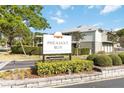 Community sign for Pheasant Run at Rosewood Town Condominiums, with lush landscaping at 4584 Pheasant Run Dr # B, Orlando, FL 32808