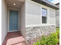 Close up shot of the front entryway with brick pavers and a blue front door at 4717 Jasmine Cir, Leesburg, FL 34748