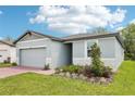 An inviting one-story home with a two-car garage, with a well-maintained lawn and landscaping at 4732 Jasmine Cir, Leesburg, FL 34748