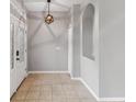 Bright entryway with tile flooring, decorative niche, and stylish geometric pendant lighting at 600 Rob Roy Dr, Clermont, FL 34711